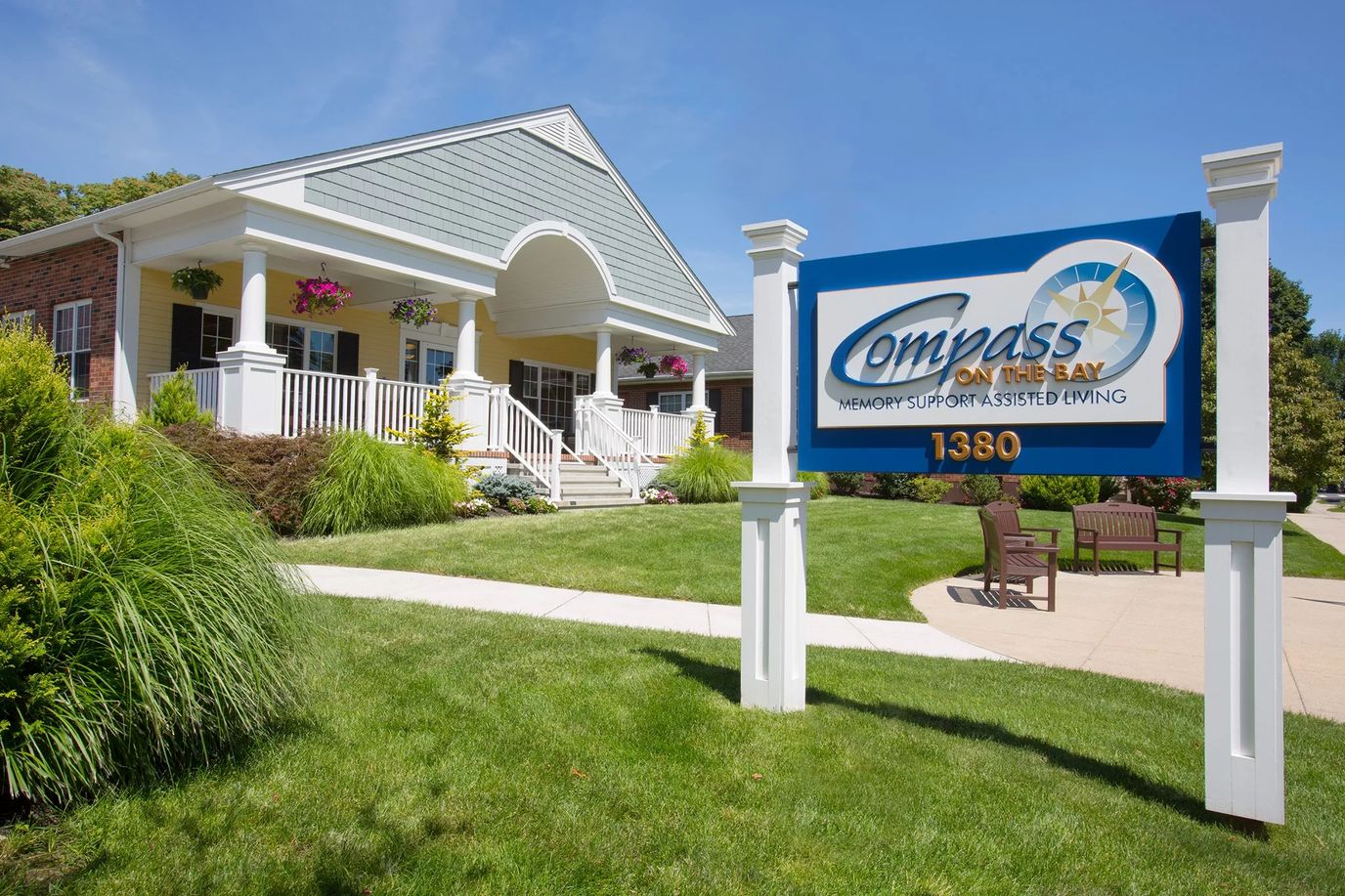 Exterior view of Compass on the Bay with signage