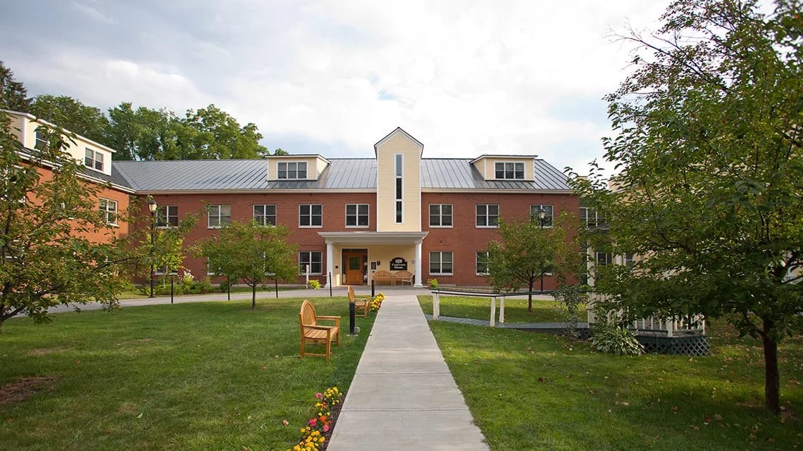 Front view of the Converse Home building with pathways and trees