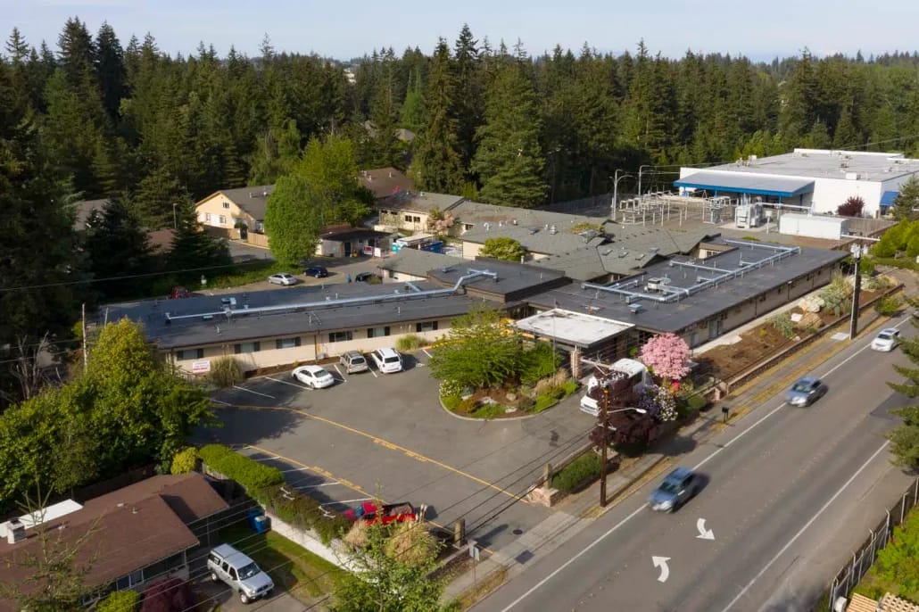 Aerial view of a senior living facility surrounded by trees