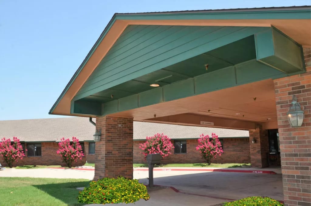 Entrance of Noble Care Center with blooming flowers