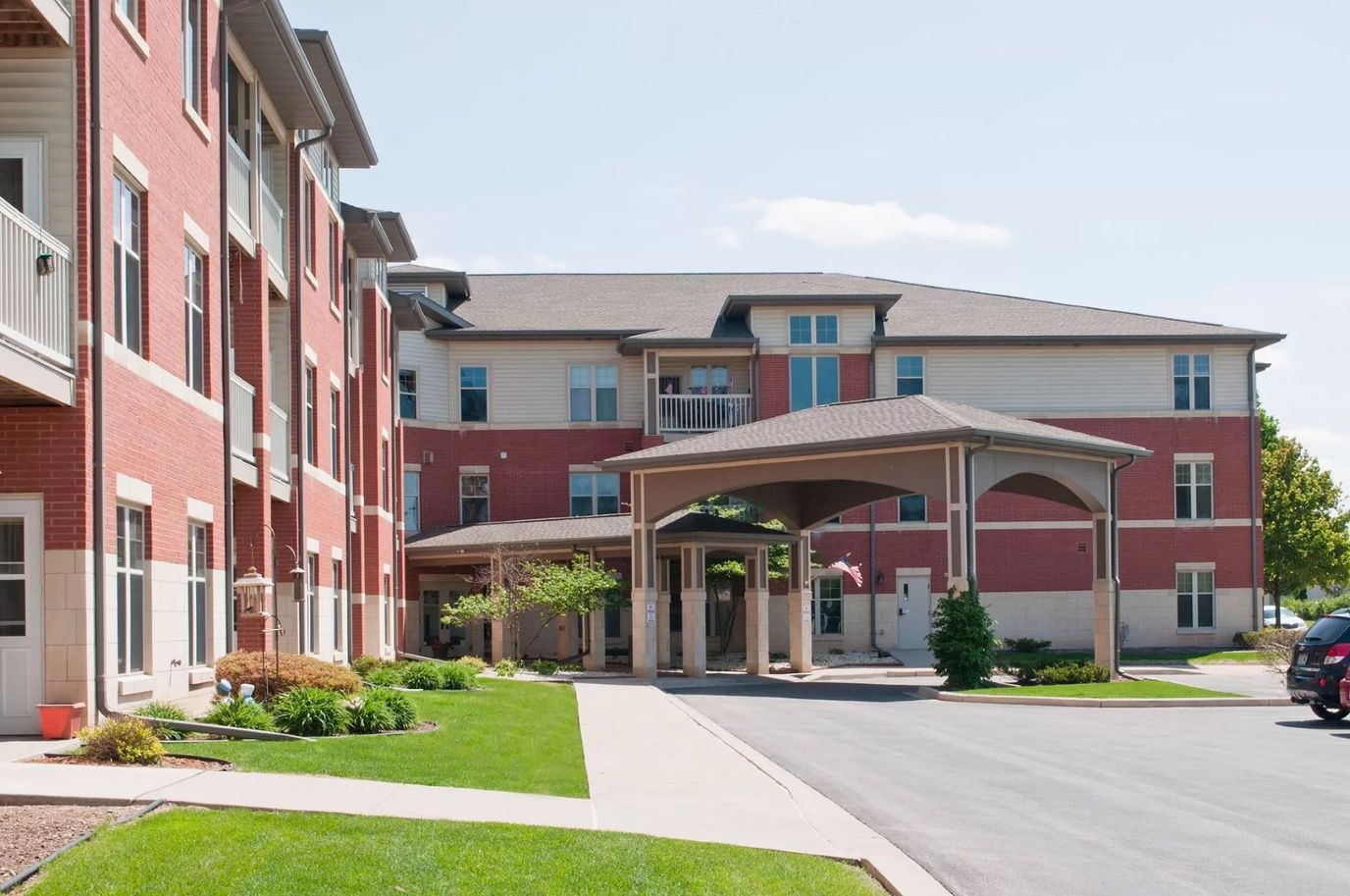 Exterior view of a senior living facility with landscaping