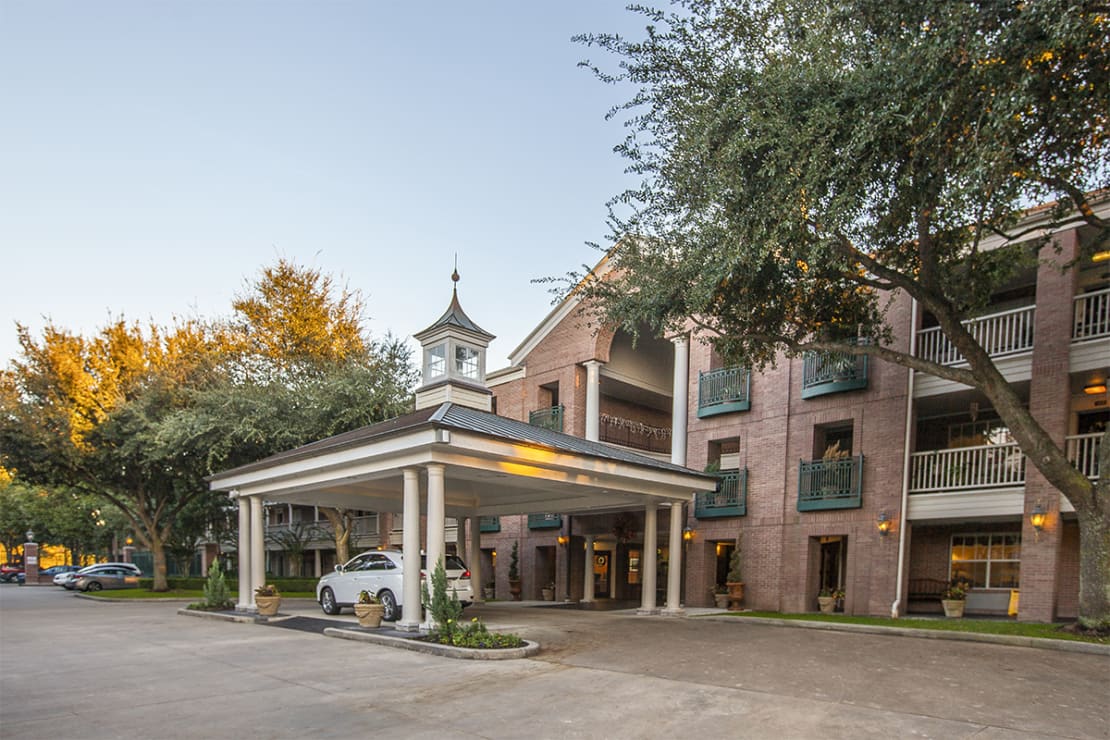 Building exterior with covered entrance and landscaping