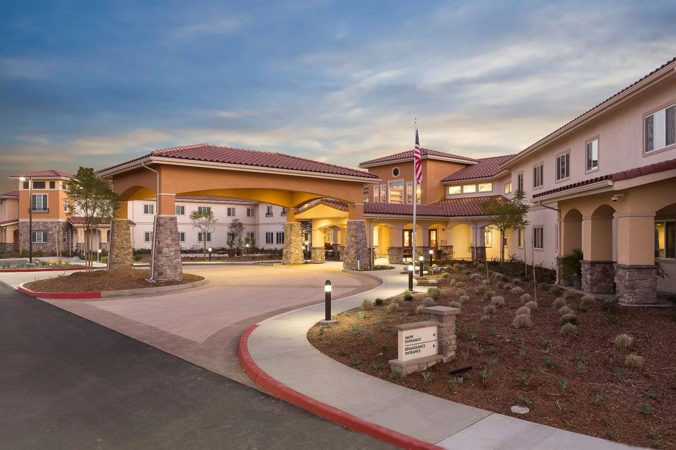 Welcoming entrance of Estancia Del Sol facility at dusk
