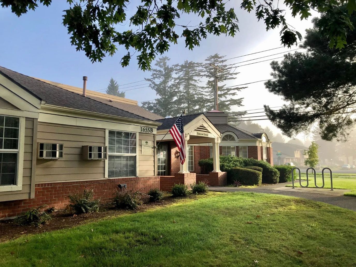 Exterior view of Farmington Square Gresham with flag