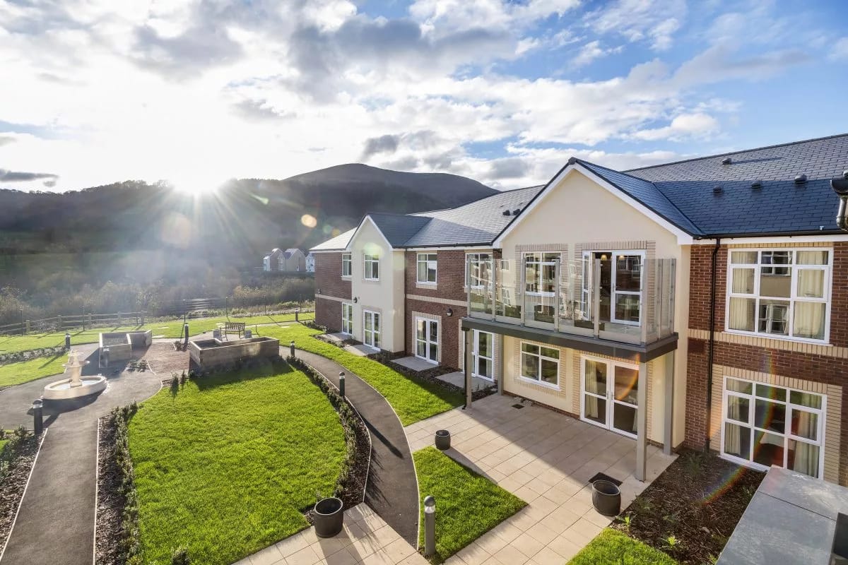 Exterior view of Foxhunters Care Community with gardens