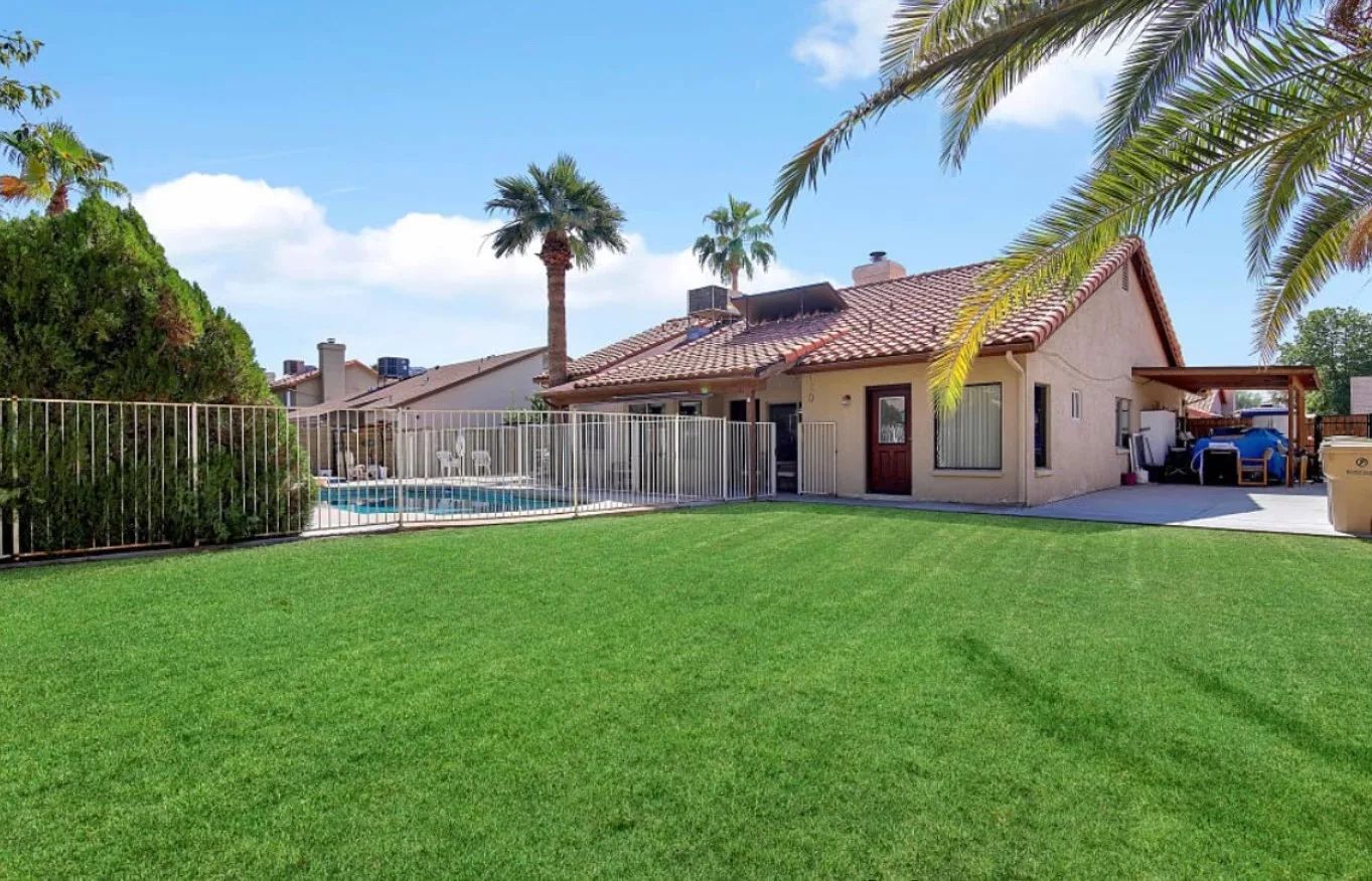 Exterior view of a residential building with green lawn