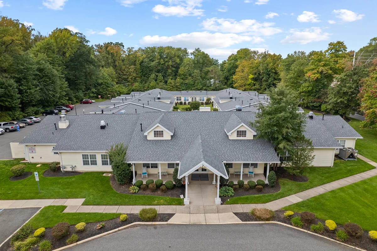 Aerial view of a senior living facility surrounded by greenery.