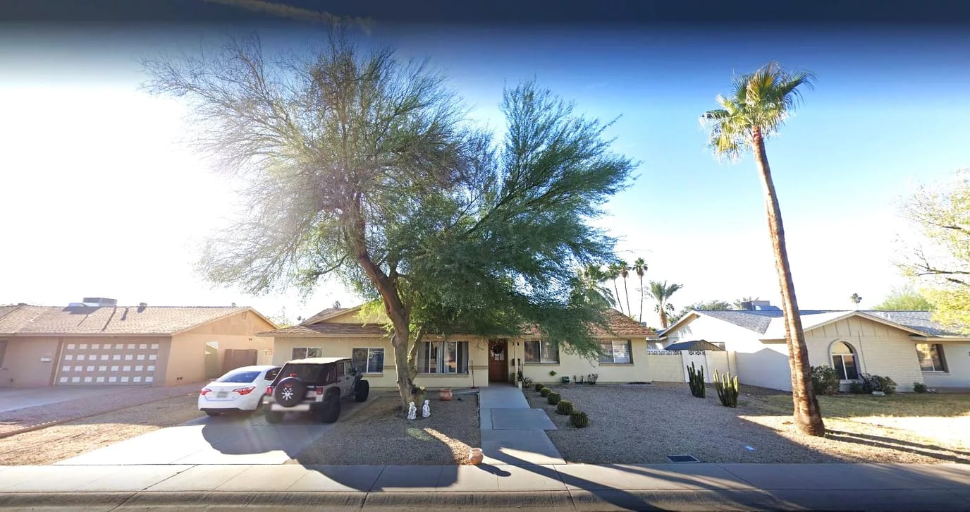 Exterior view of a residential care home with palm trees