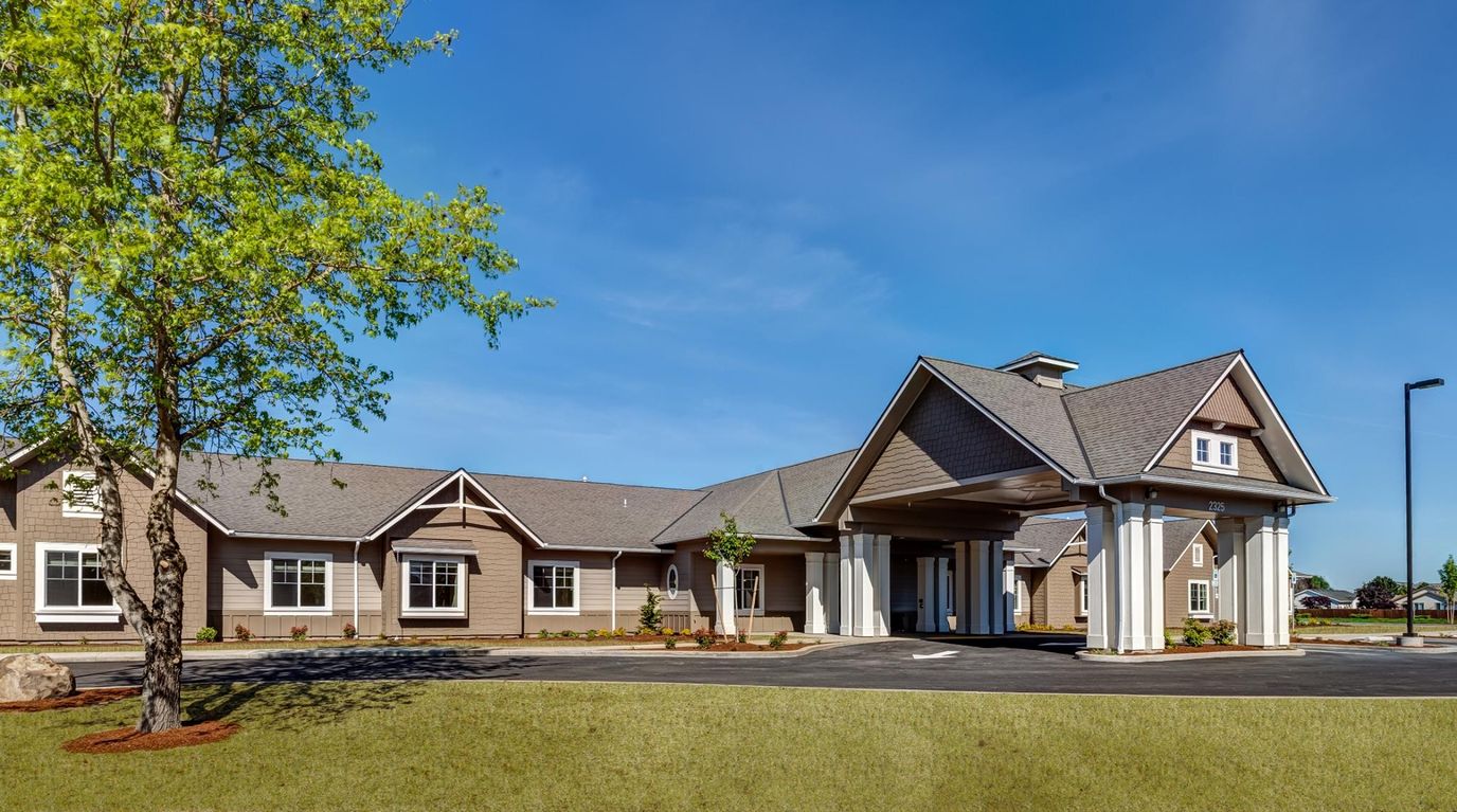 Exterior view of Heartwood Place Memory Care facility with parking