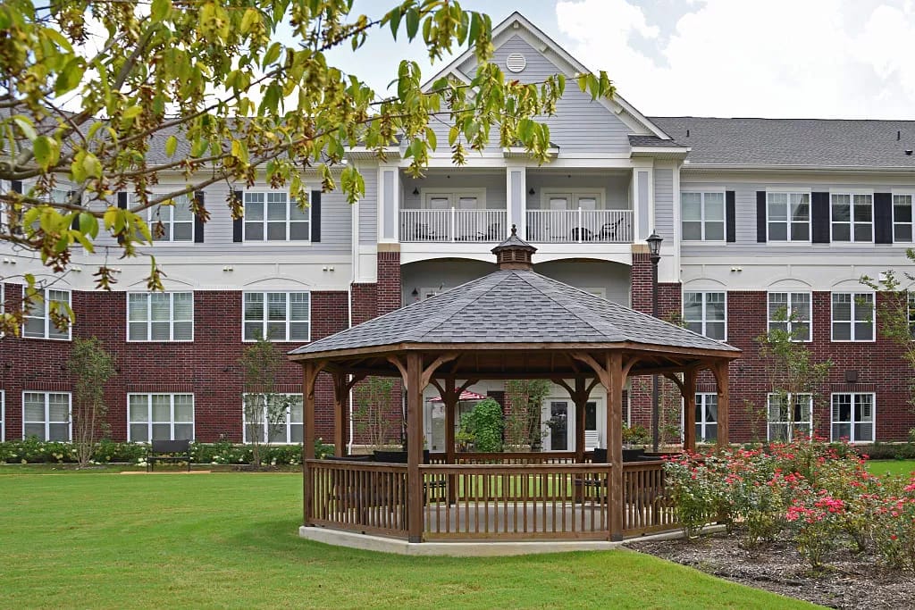 Exterior view of a senior living facility with gazebo