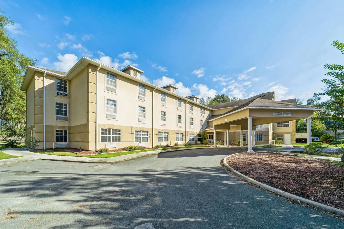 Exterior view of Highland Place facility with clear skies