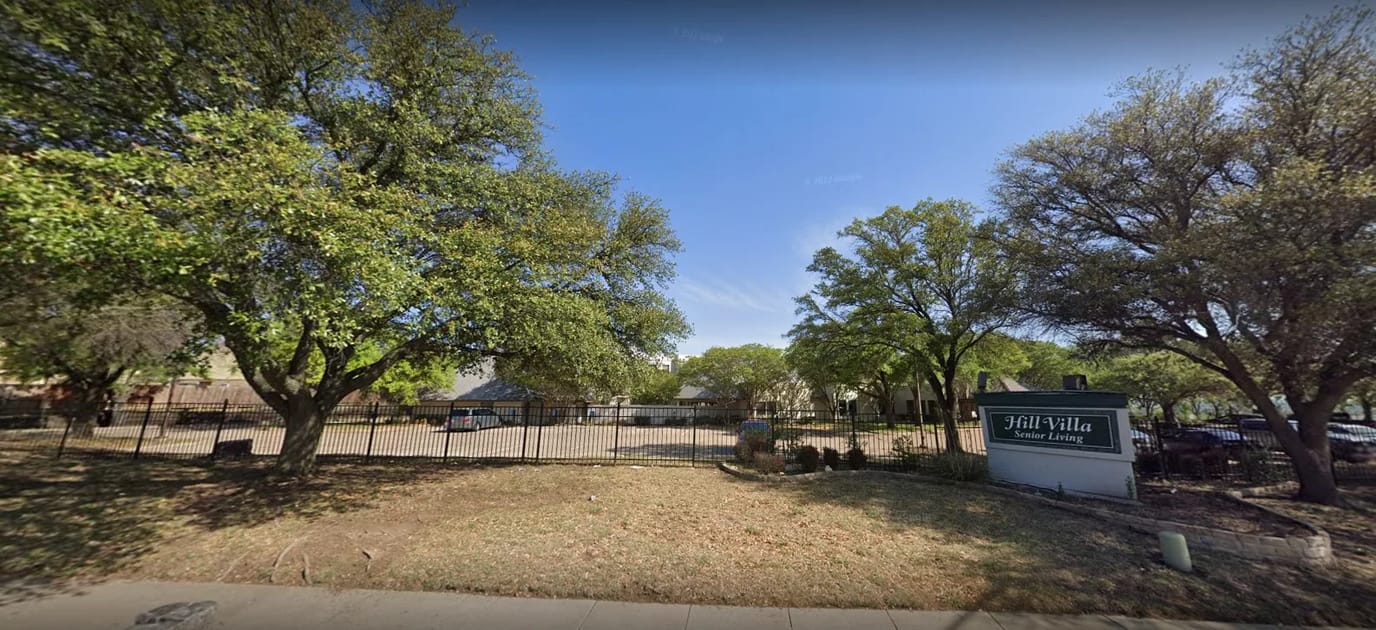 Exterior view of Hill Villa Senior Living with trees