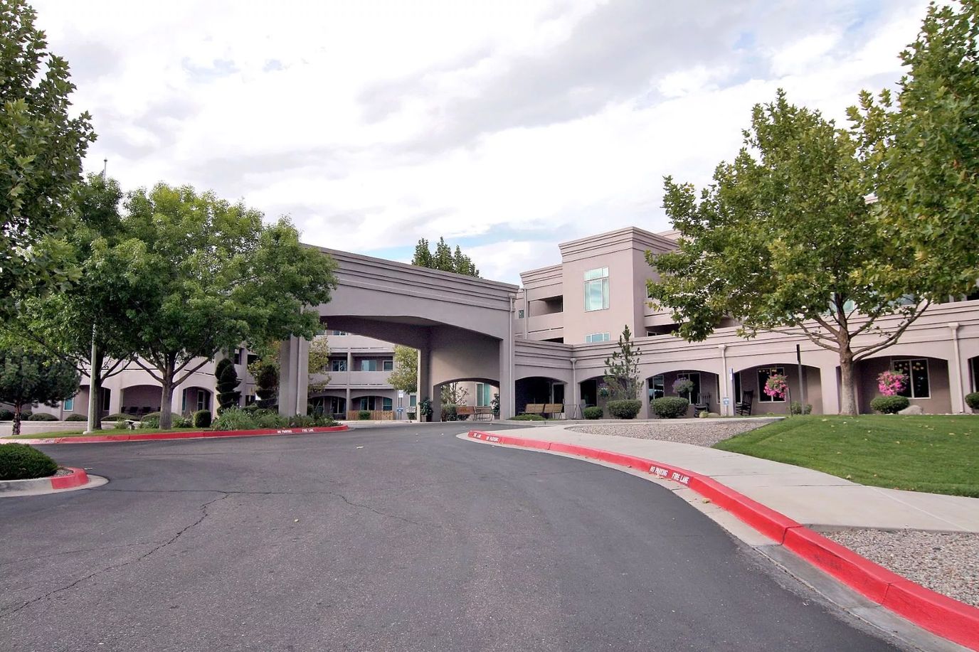 Exterior view of a senior living facility surrounded by trees