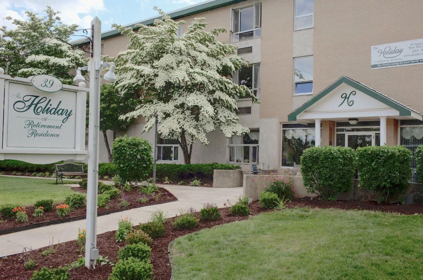 Exterior view of the Holiday Retirement Community building and sign