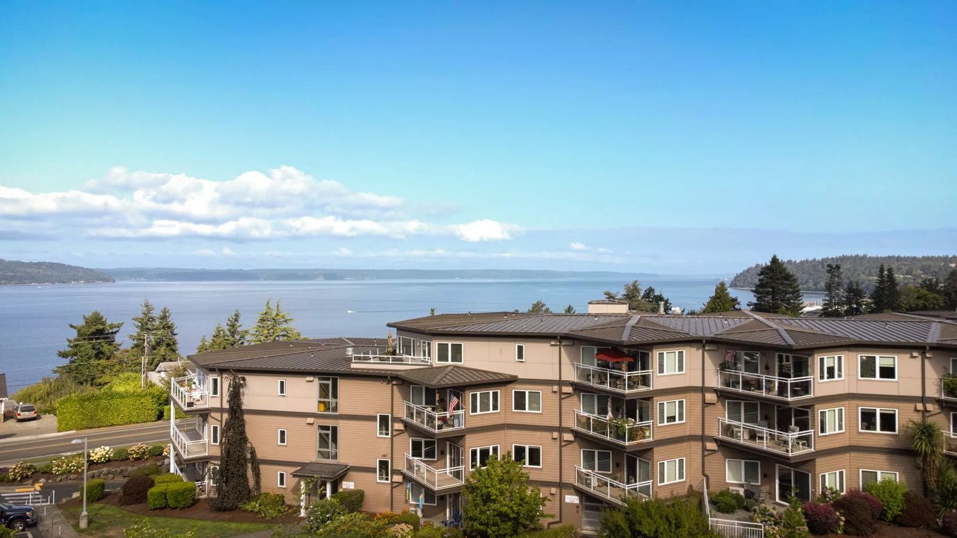 Exterior view of a senior living facility by the water