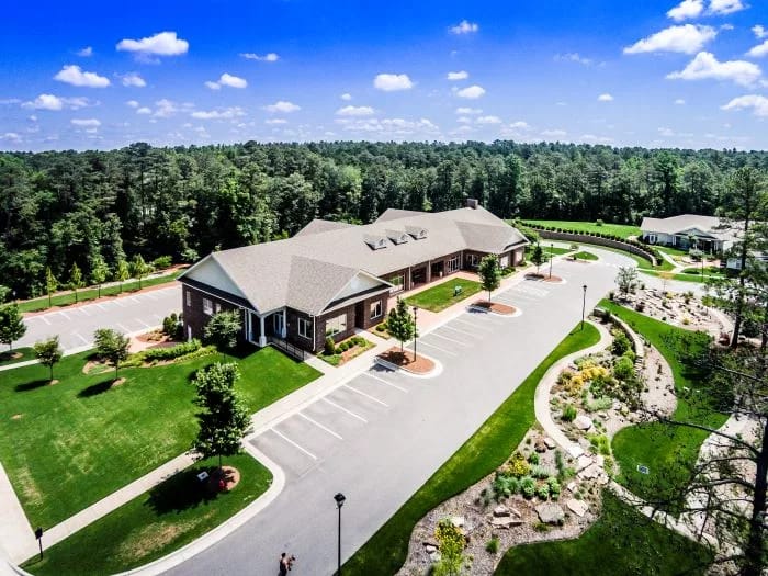 Aerial view of a senior living facility surrounded by greenery