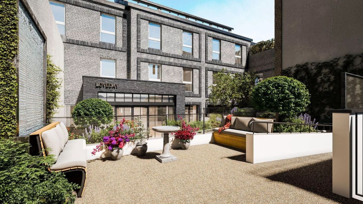 Outdoor seating area with flowers at Loveday Kensington