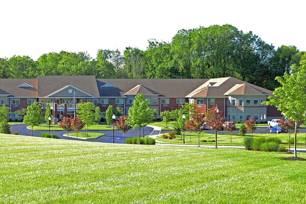 Exterior view of Magnolia Springs East facility amidst gardens
