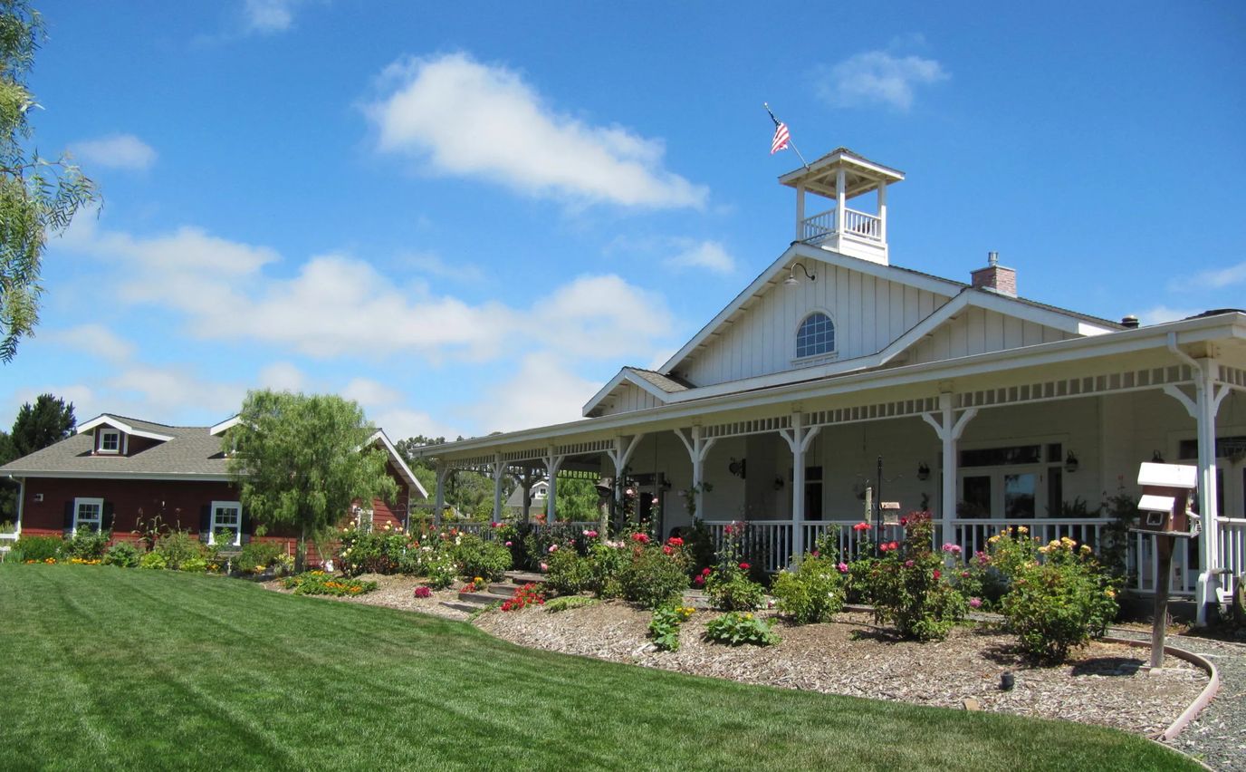 Exterior view of a senior living facility with landscaped gardens
