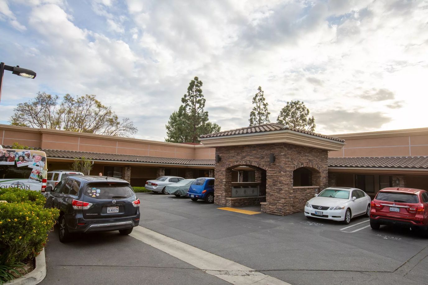 Exterior view of Mainplace Senior Living facility with parking area