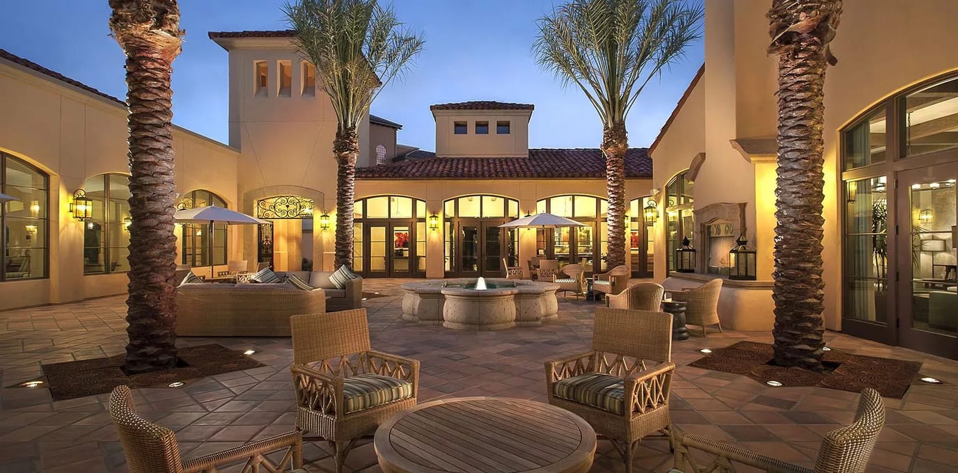 Elegant outdoor courtyard area with seating and palms