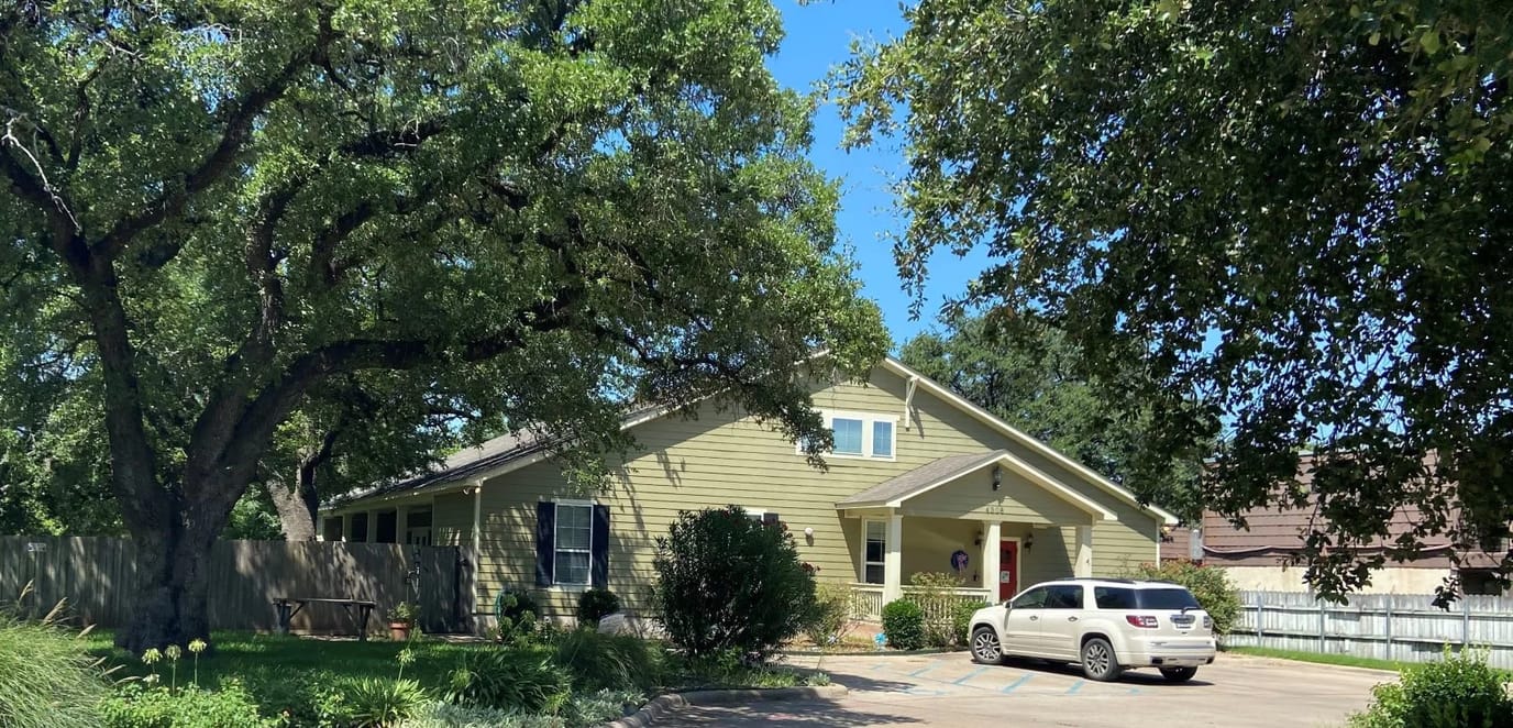 Exterior view of Mercy House Waco surrounded by trees