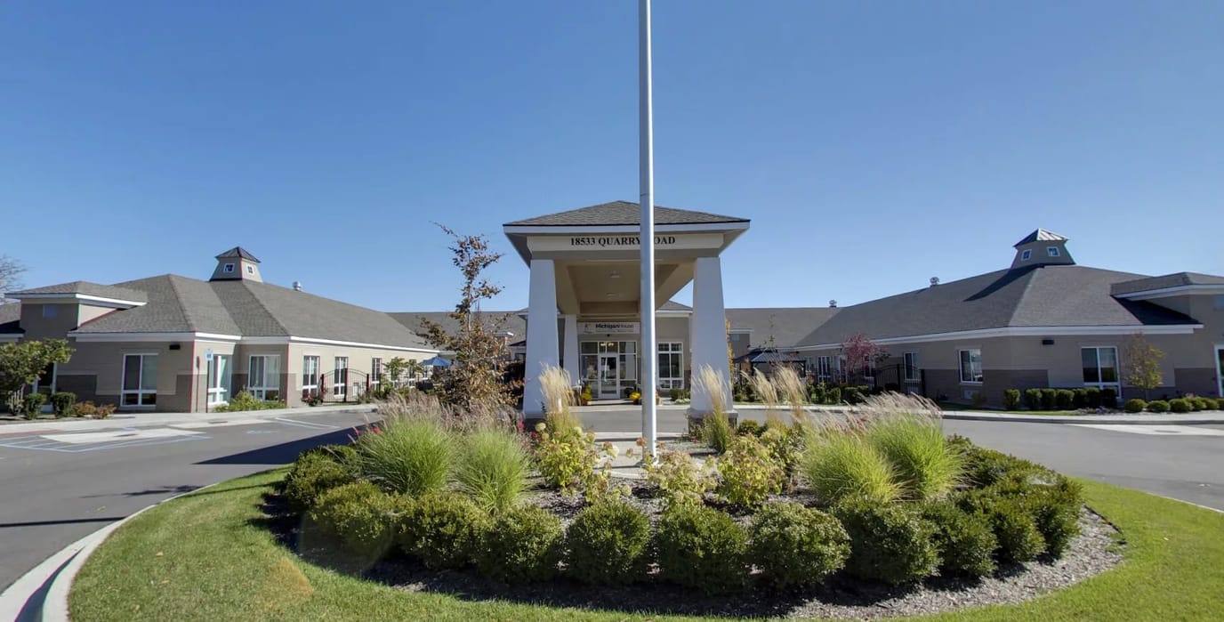 Front entrance of Michigan House Senior Living with landscaping