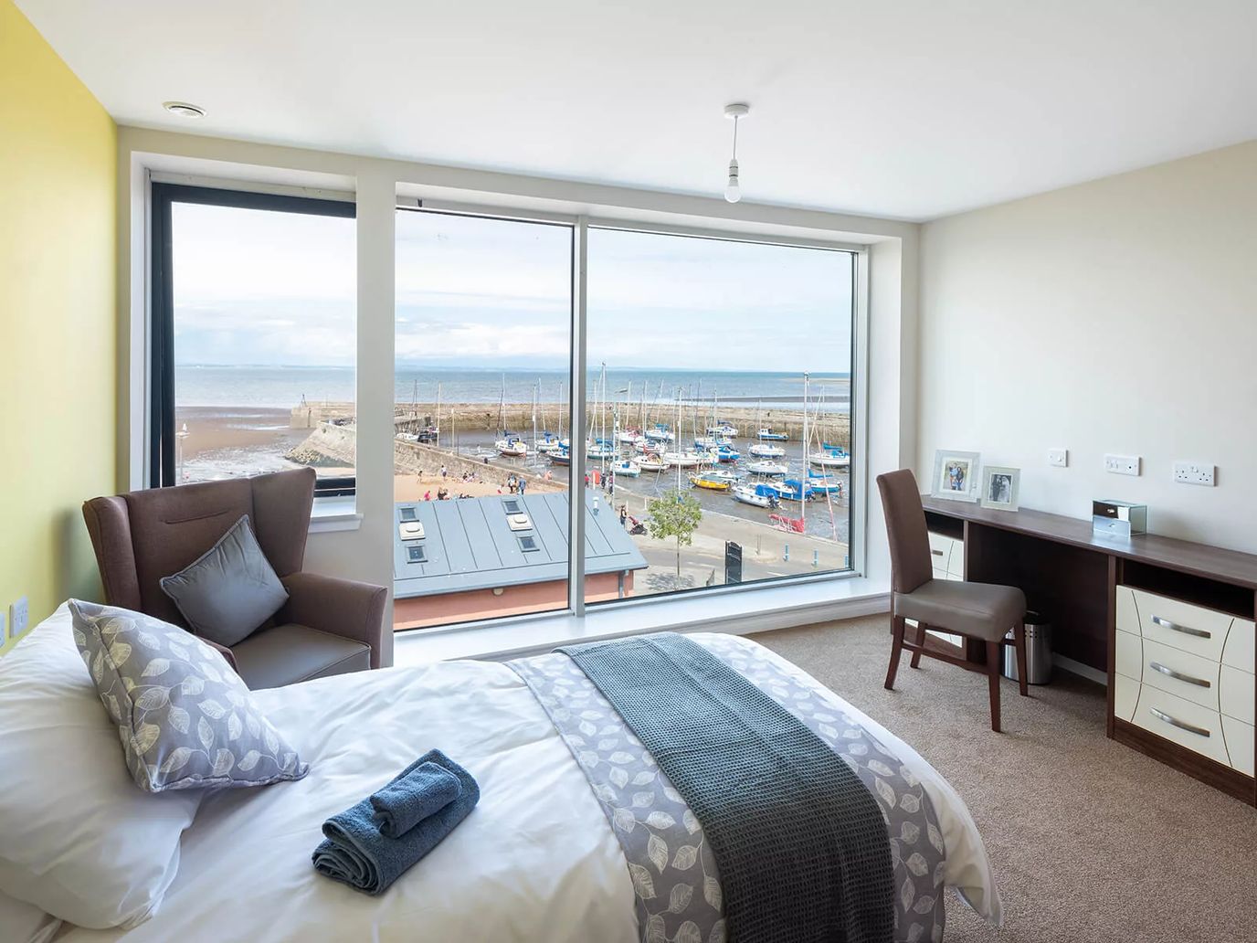 A bright and modern room with a view of the marina