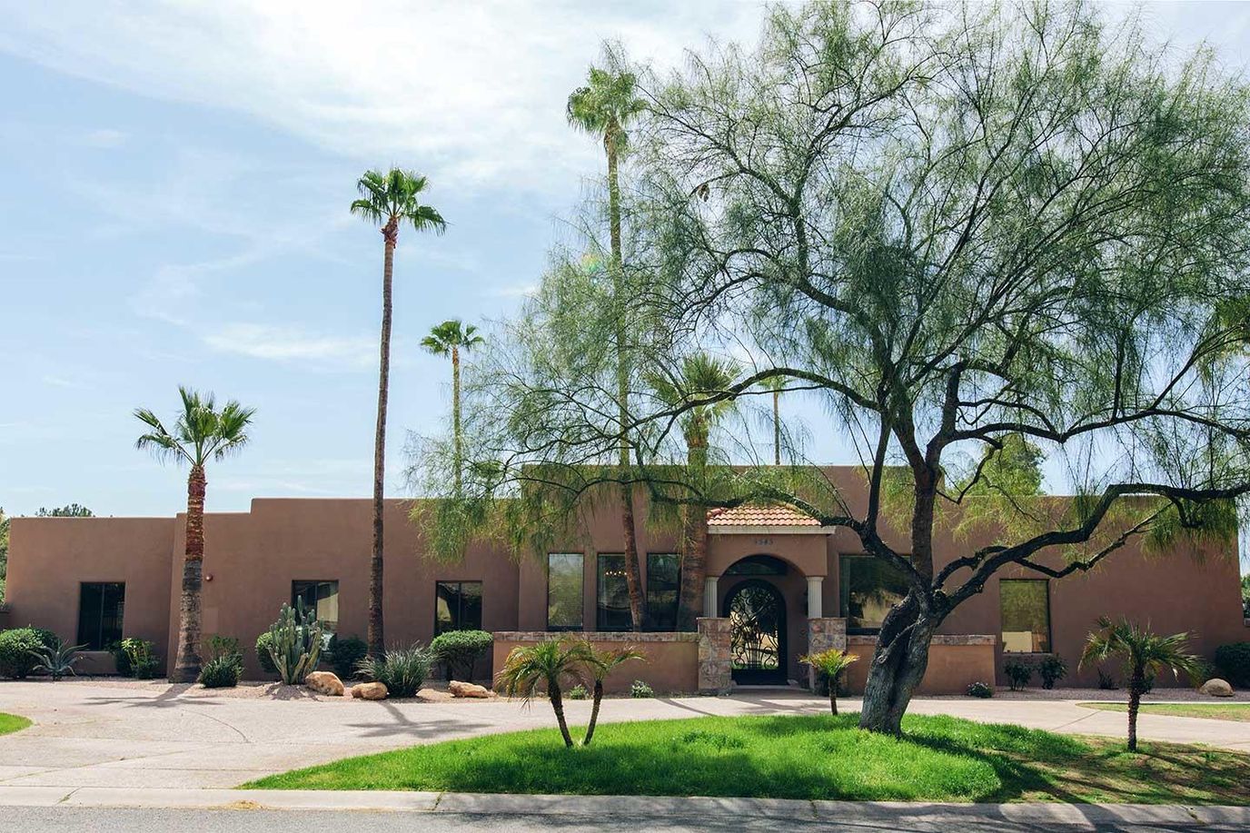 Exterior view of Oakmont Assisted Living with palm trees