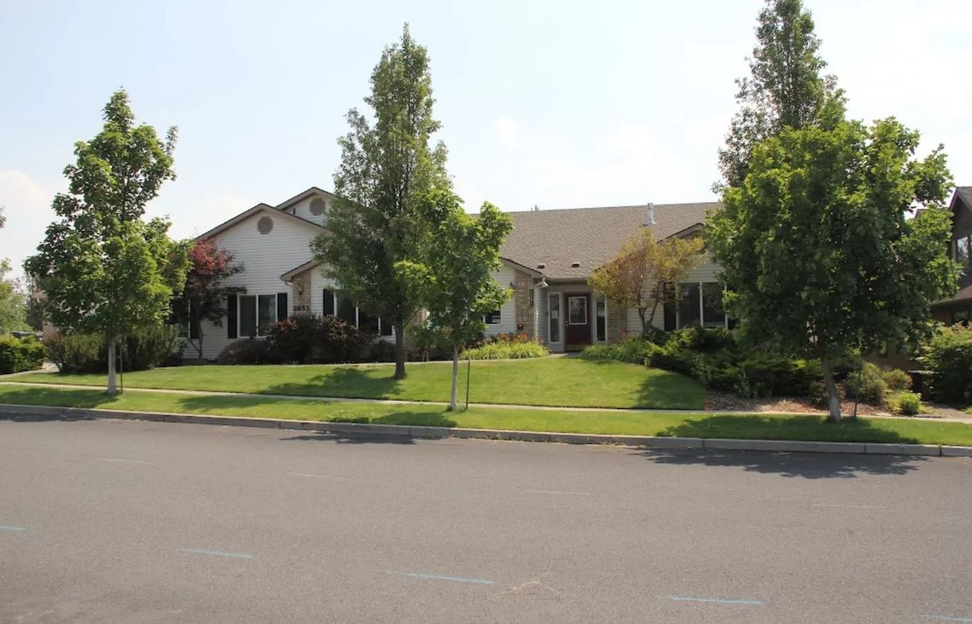 Exterior view of the Pacific Living Centers facility surrounded by landscaping