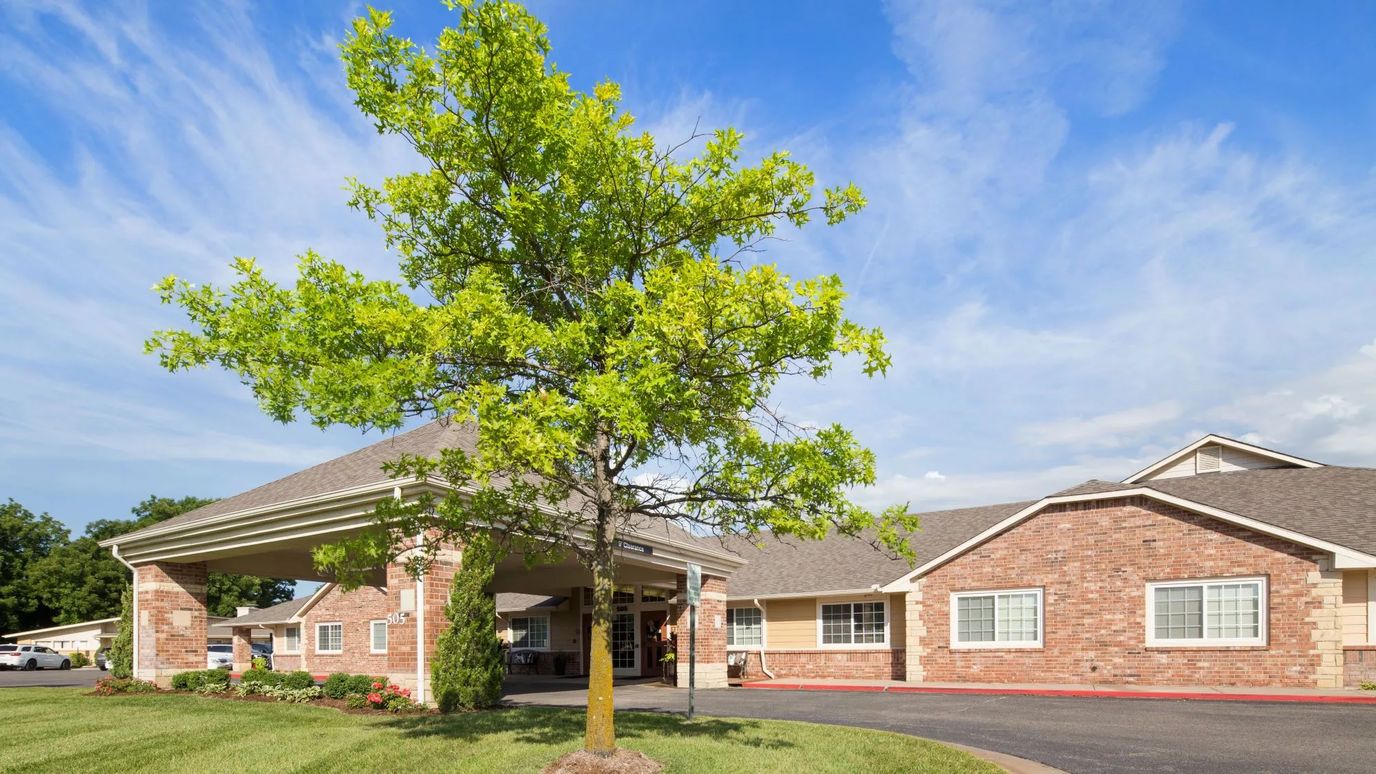 Exterior view of a senior living facility with landscaped entrance