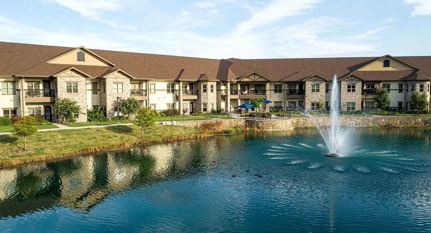 Aerial view of the facility with a pond and fountain