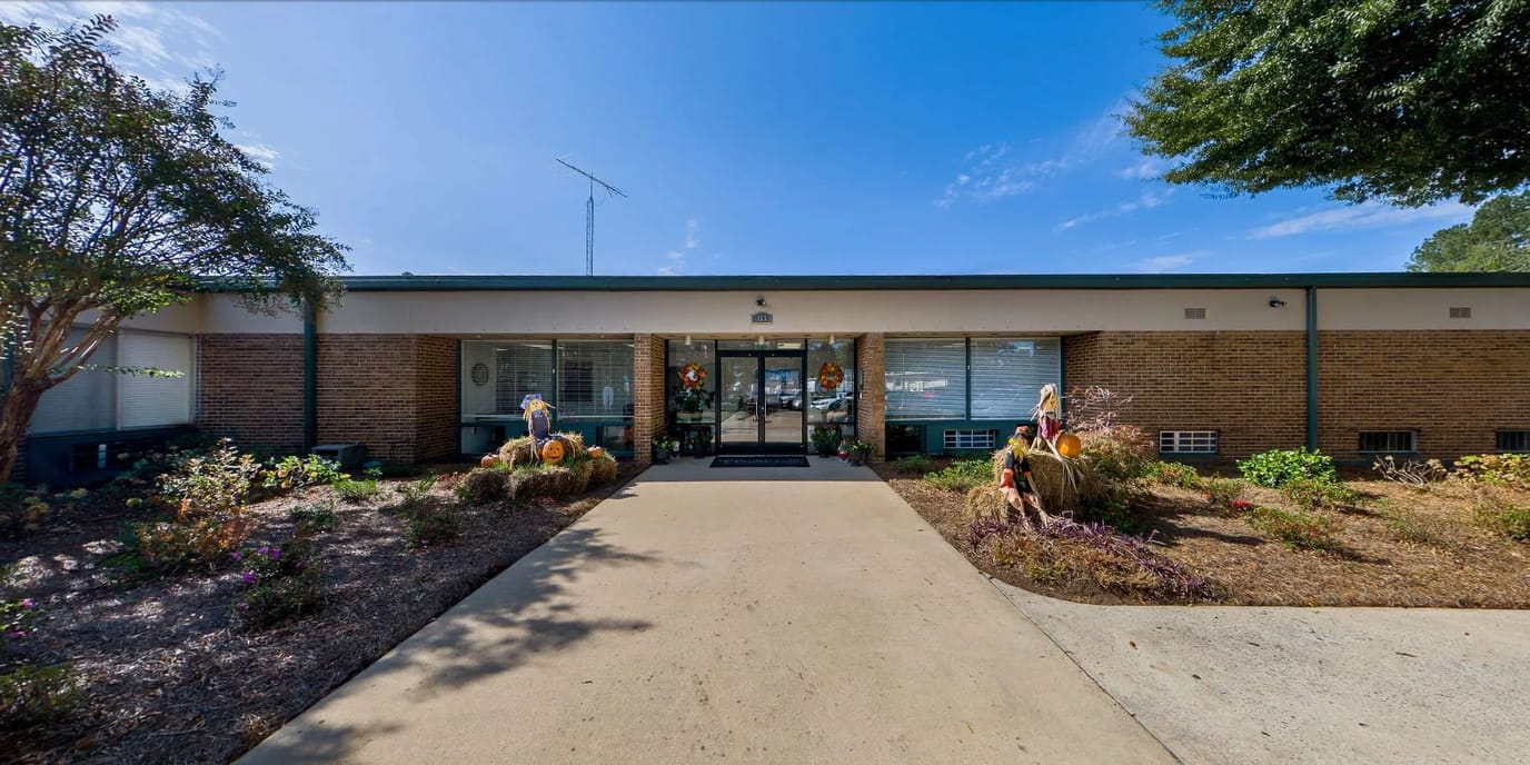 Entrance of the facility with garden and decorations