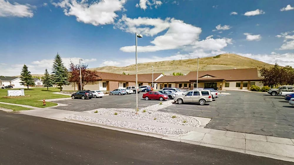 Exterior view of the Rocky Mountain Care facility with parking lot
