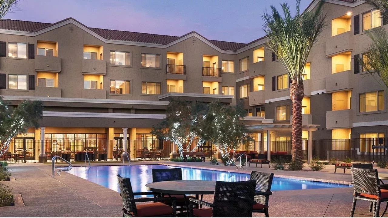 Exterior view of the facility with a pool and outdoor space