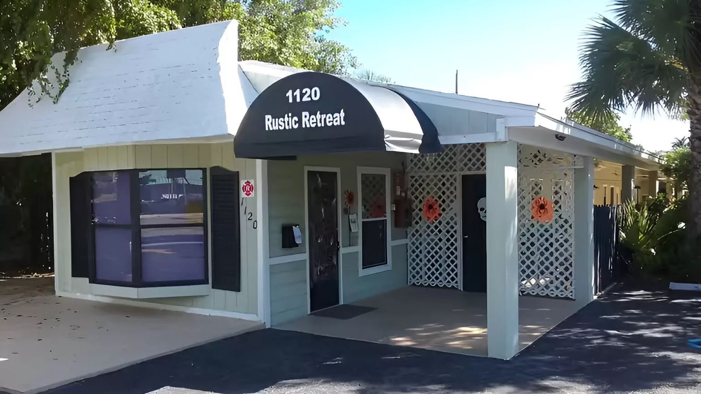 Exterior view of Rustic Retreat building with signage