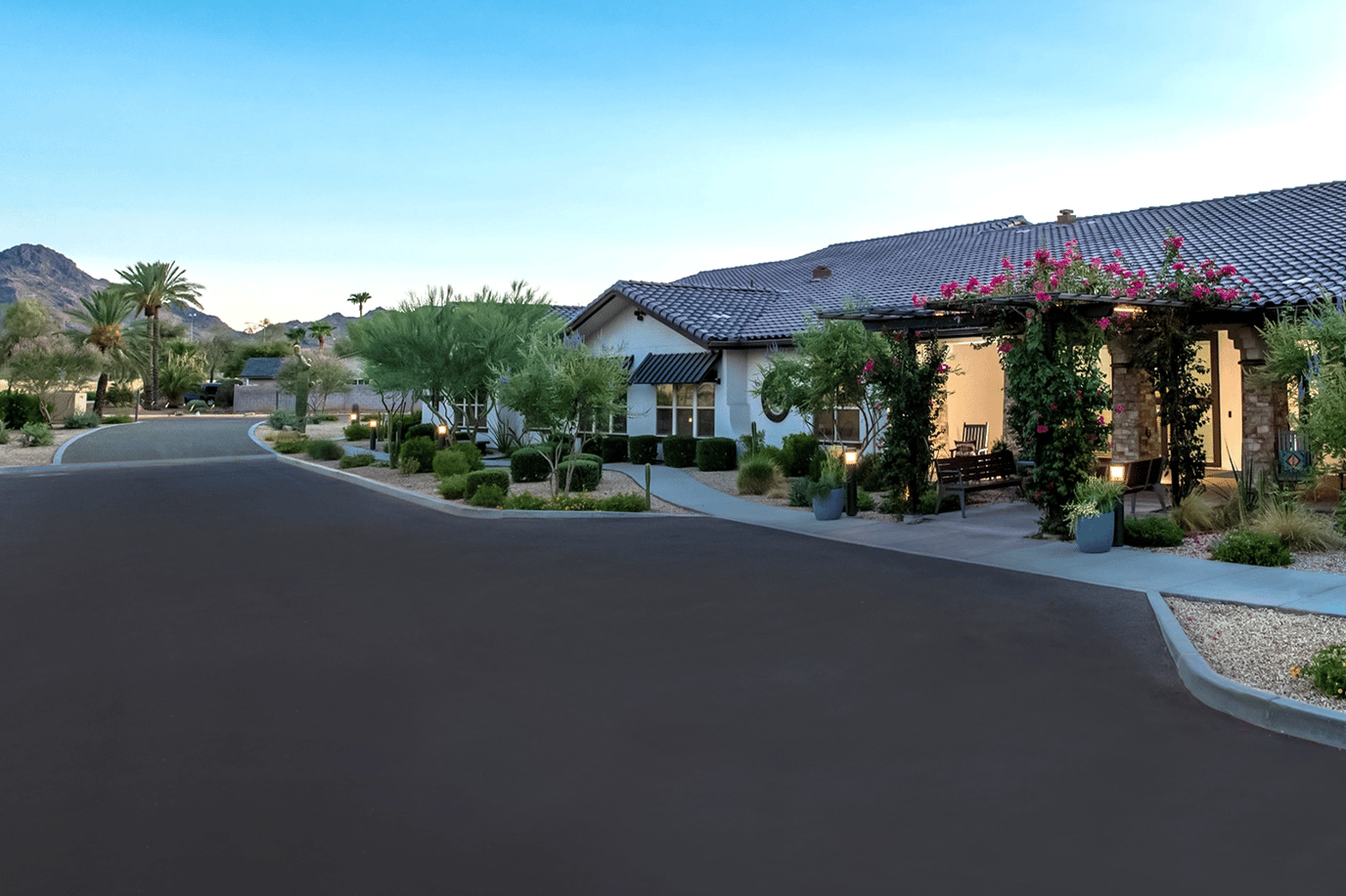 Exterior view of a memory care facility surrounded by greenery