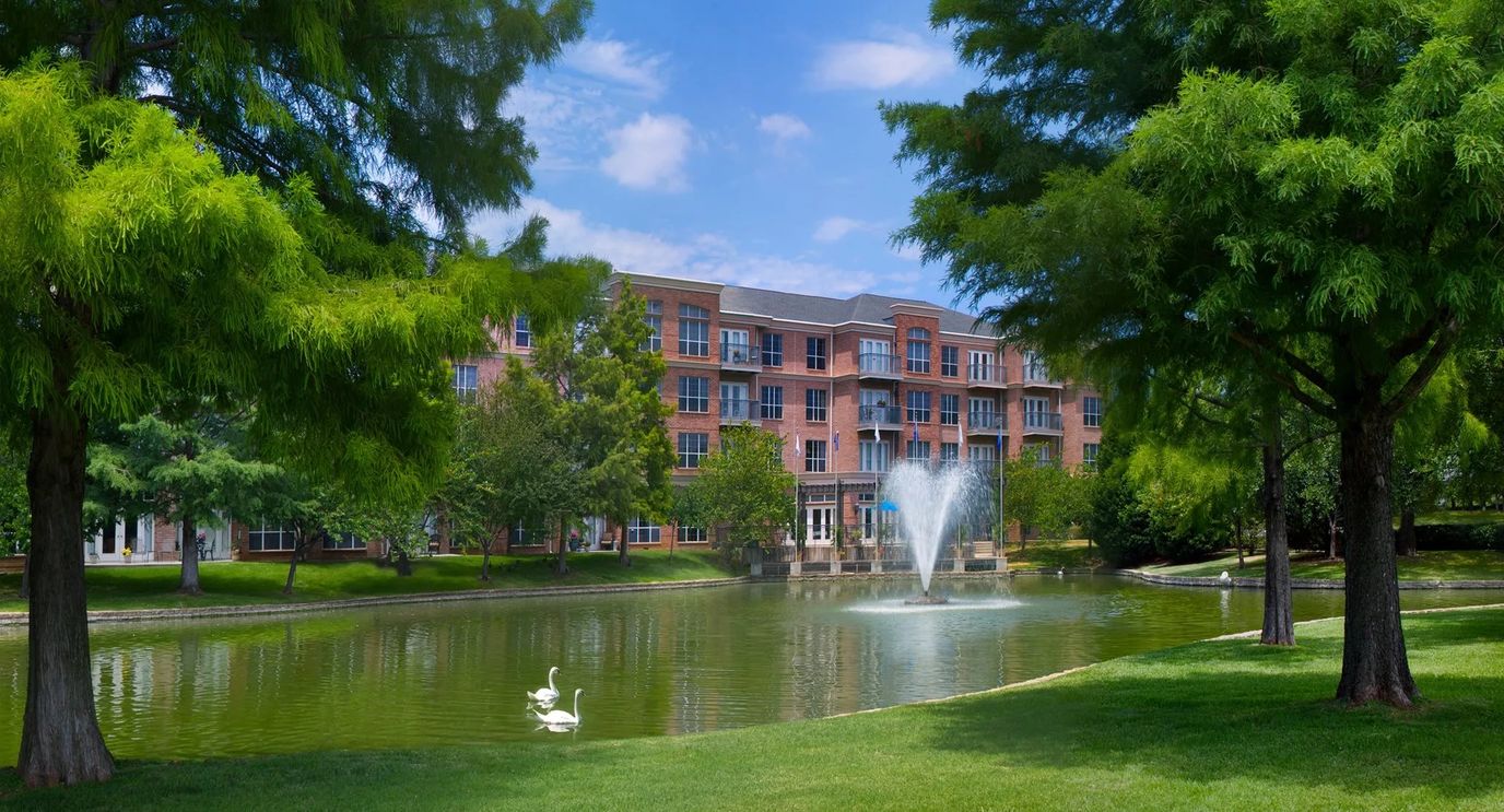 Exterior view of Signature Pointe near a pond