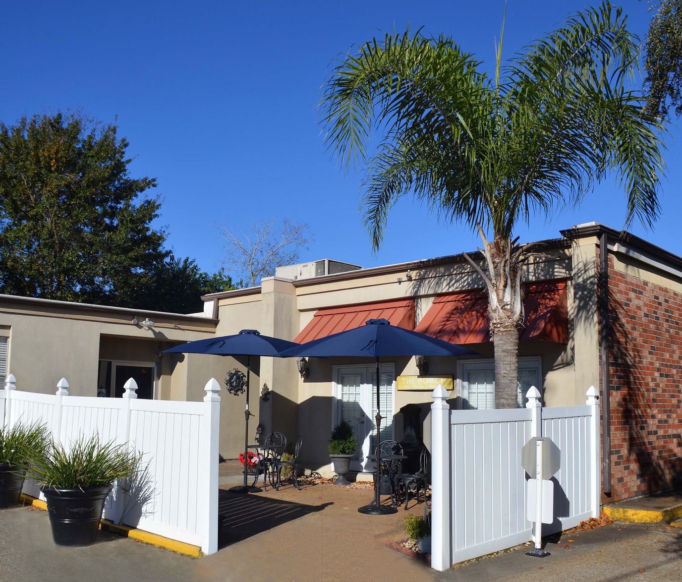 Outdoor seating area with umbrellas and landscaping