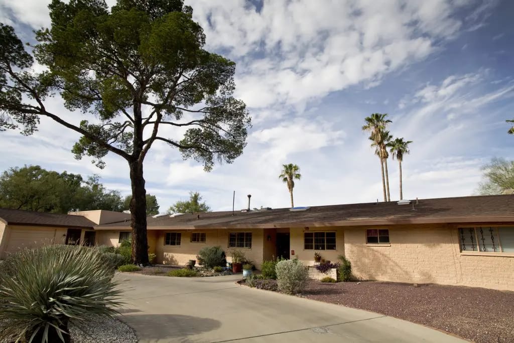 Exterior view of Starfish Care Homes with trees and shrubs