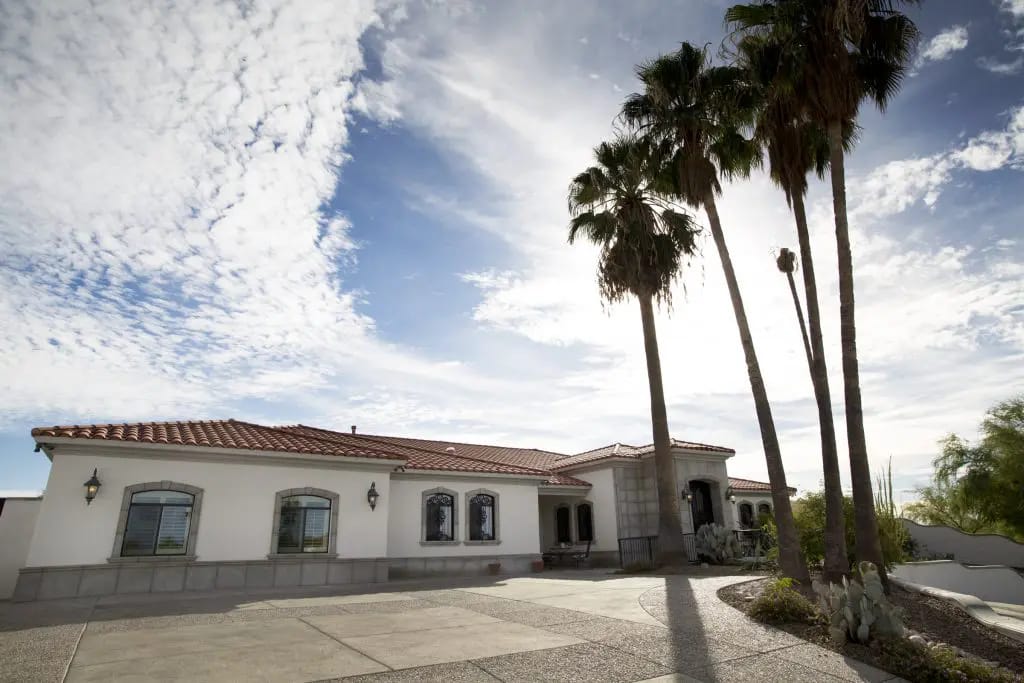 Exterior view of a senior care facility with palm trees