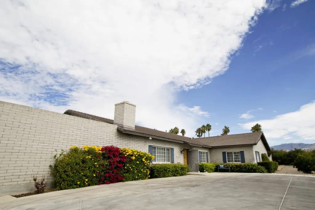 Exterior view of a senior care home with landscaping