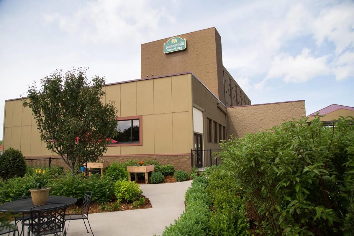 Exterior view of Summit Hill Senior Living building with greenery