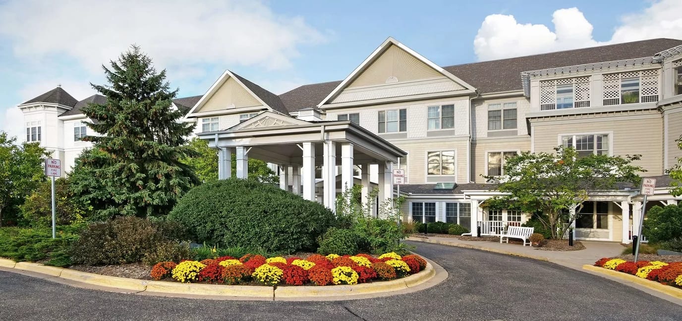 The exterior of Sunrise of Golden Valley with colorful flowers