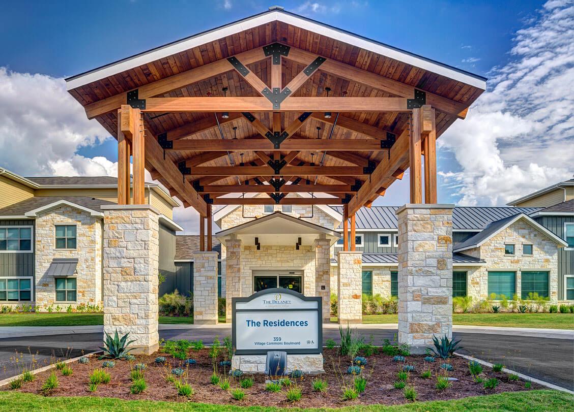 Exterior view of the facility entrance with a sign
