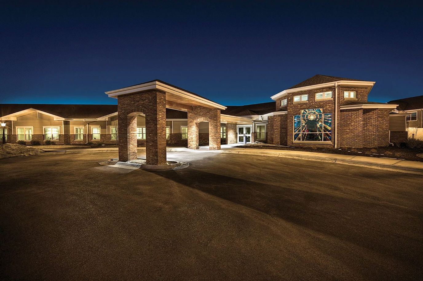 Exterior view of The Lighthouse senior living facility at night