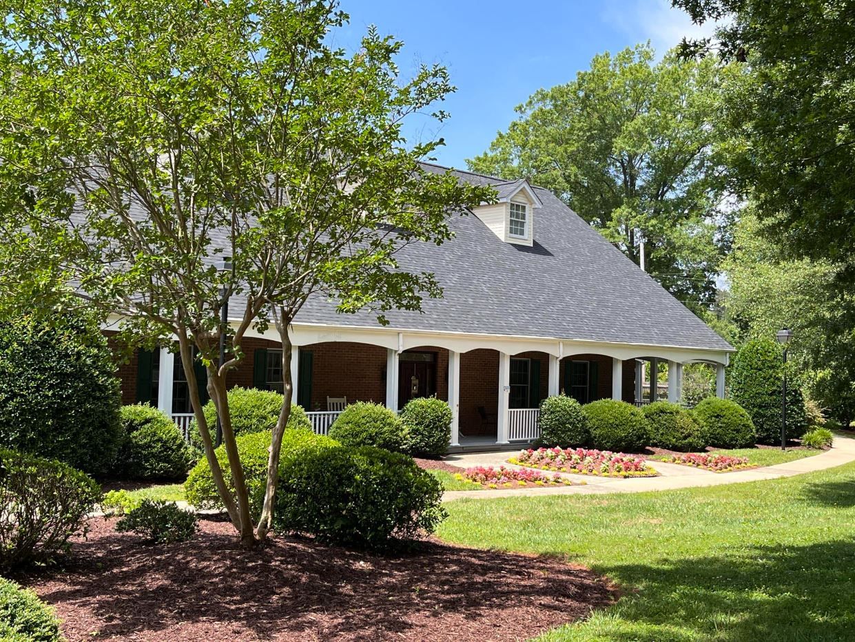Exterior view of a senior living facility with landscaped gardens