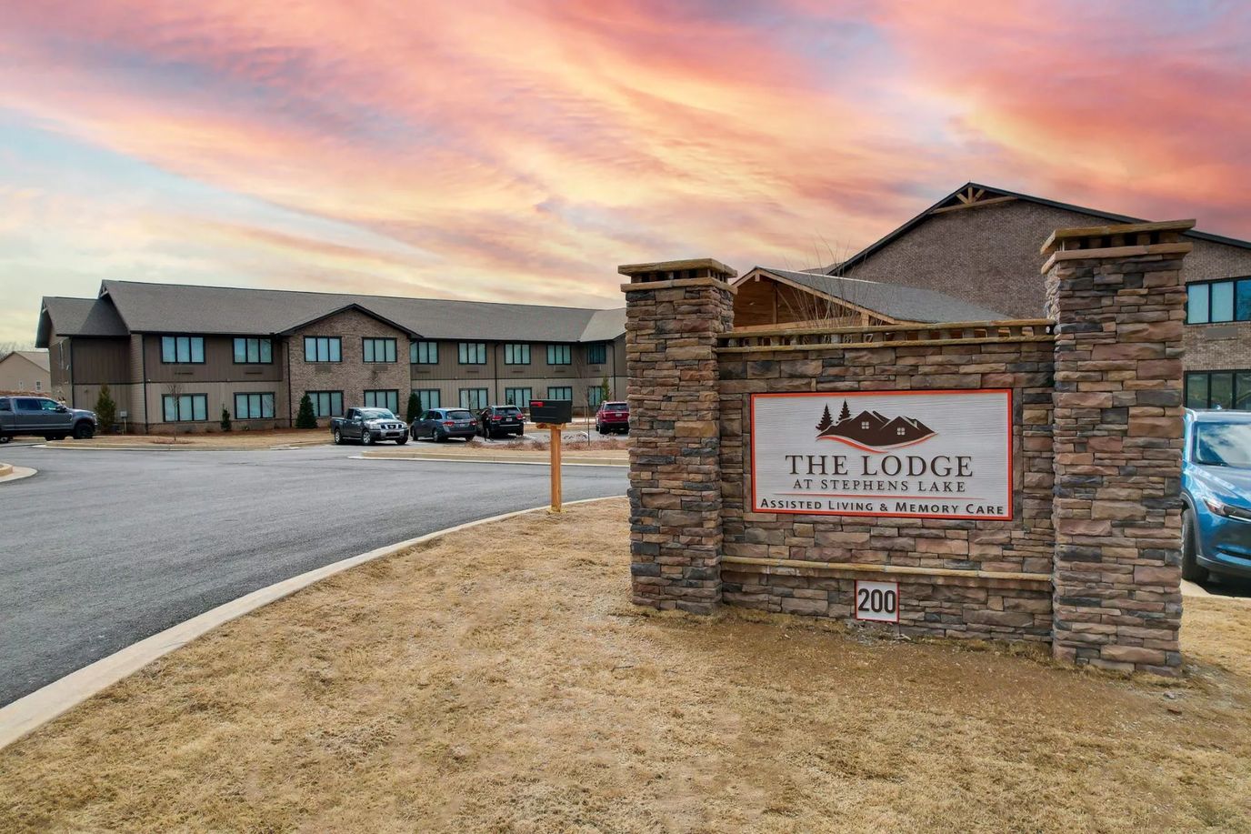 Exterior view of The Lodge at Stephens Lake with a colorful sunset