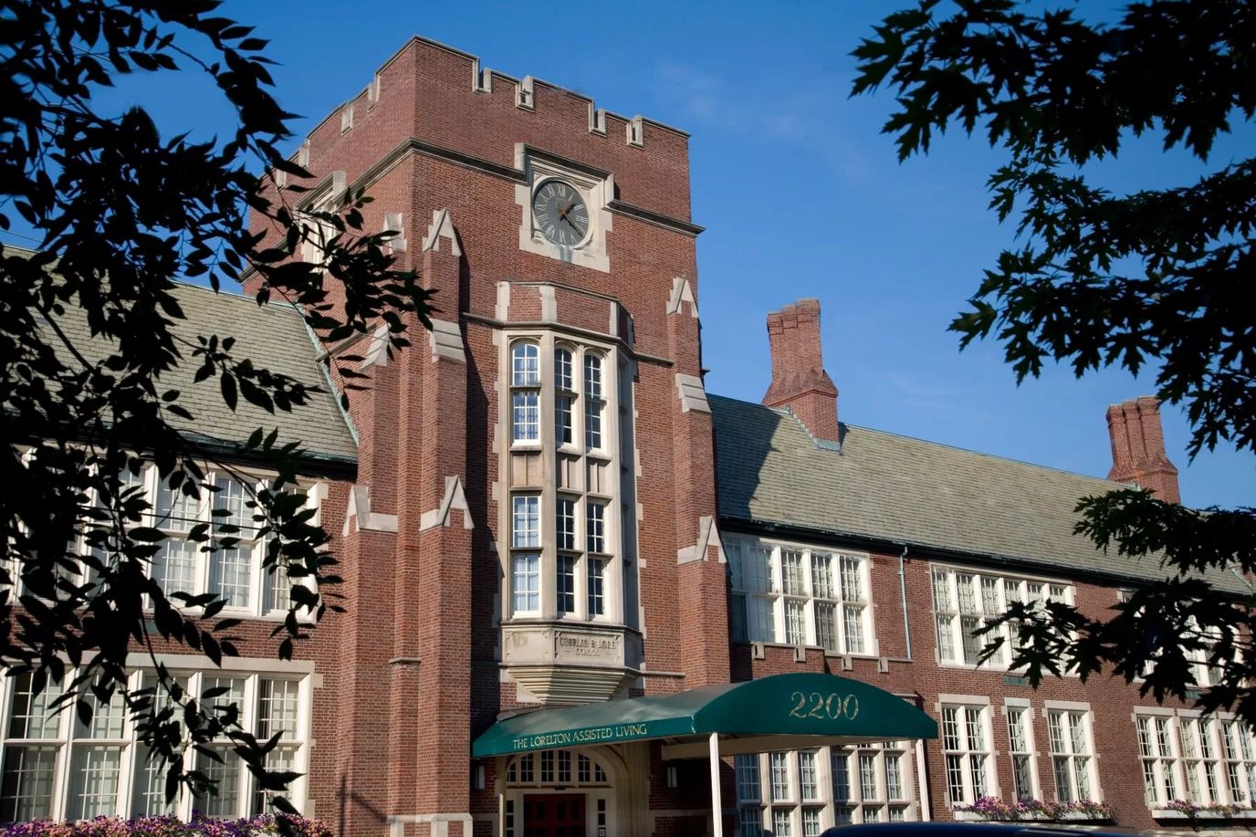 Exterior view of a senior living facility with clock tower