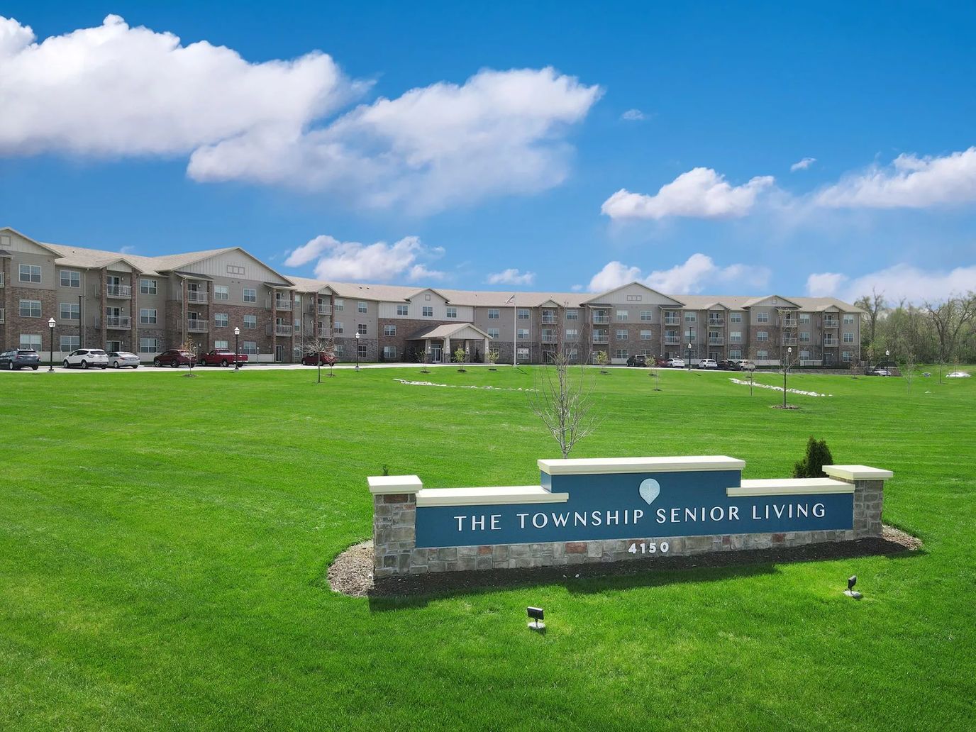 Exterior view of The Township Senior Living facility with sign